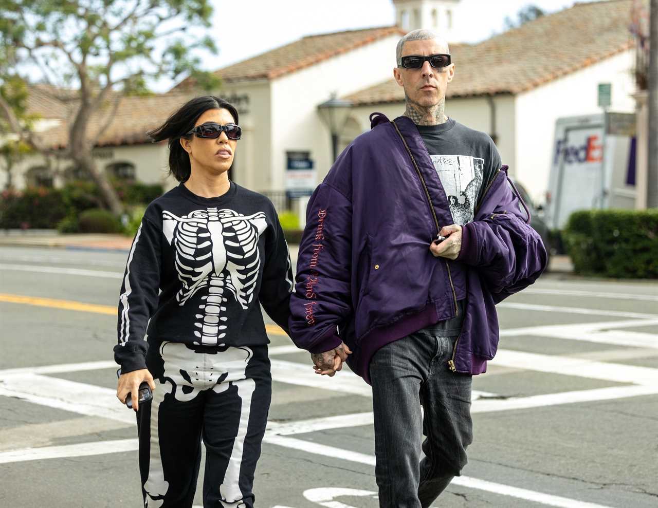 Kourtney Kardashian covers her stomach in baggy skeleton onesie after fans think she ‘subtly revealed her pregnancy’