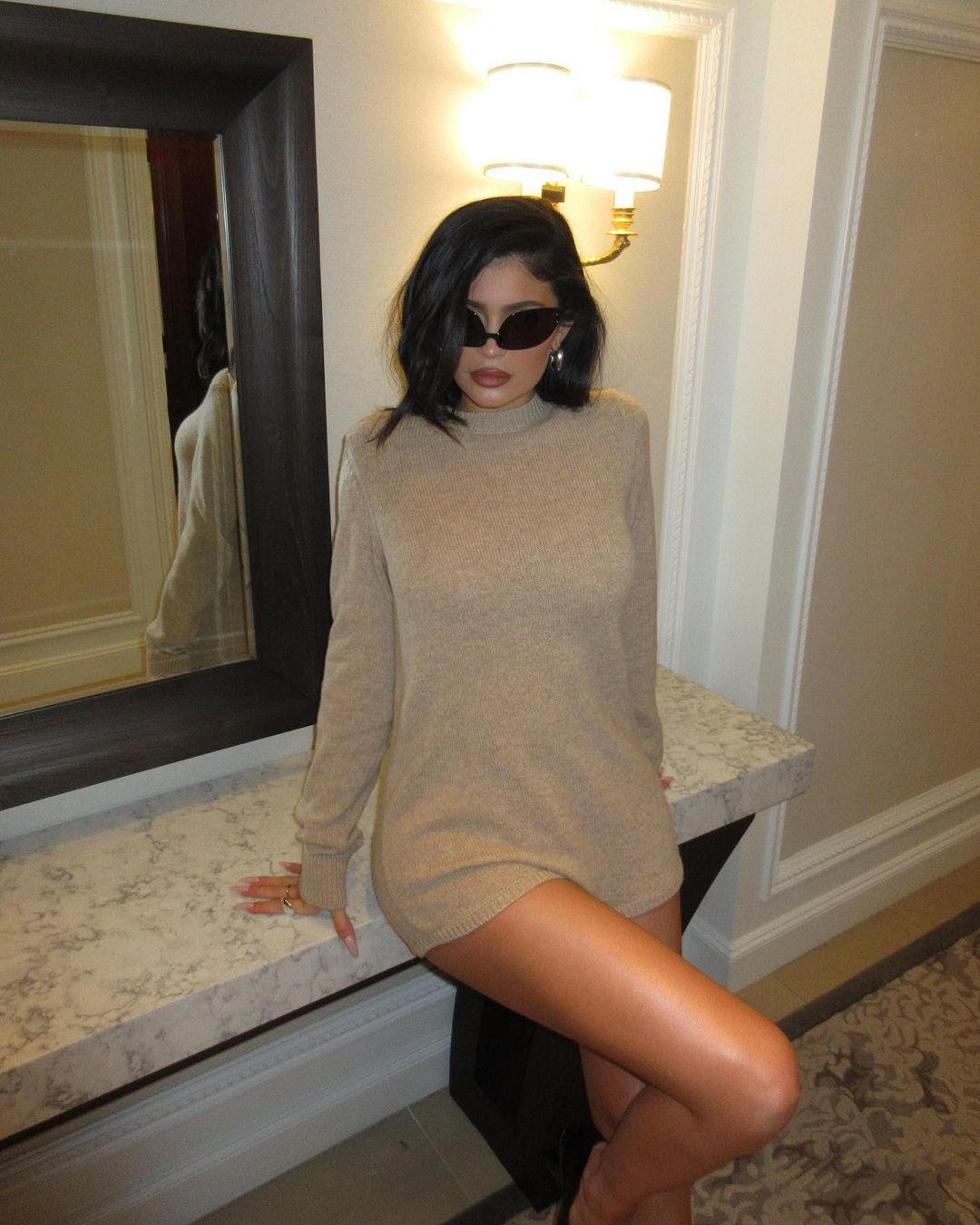 Kylie Jenner shows off bare legs in mini dress & leather jacket after she shares secret never-before-seen photos