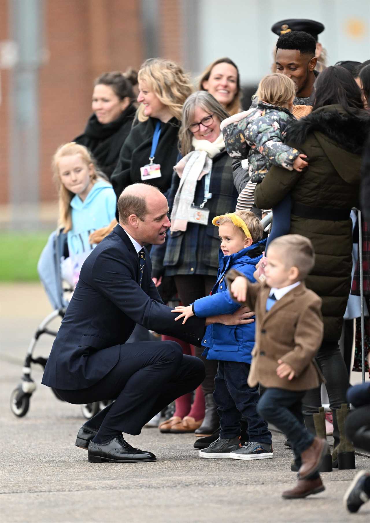 Prince of Wales hugs little boy and vows to put his picture on the royal fridge