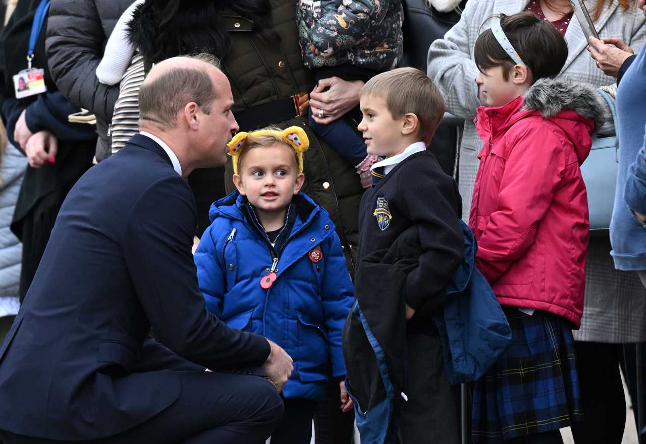 Prince of Wales hugs little boy and vows to put his picture on the royal fridge