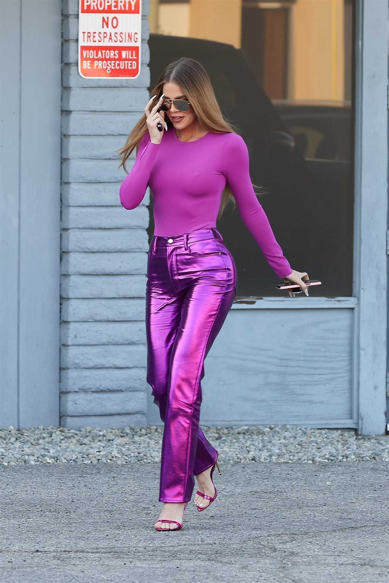 Khloe Kardashian suffers embarrassing wardrobe malfunction as she shows off shrinking legs & butt in shiny purple pants