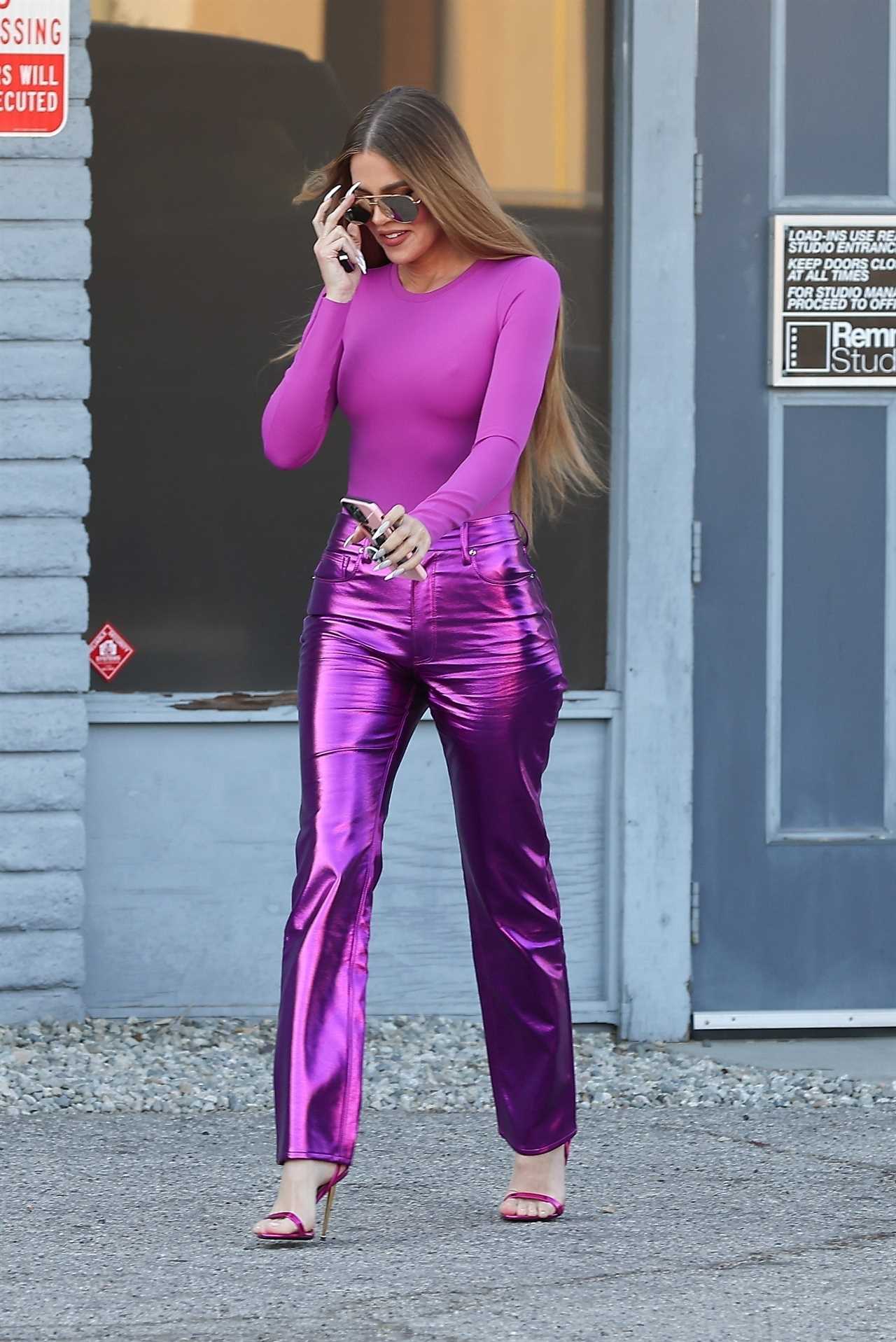 Khloe Kardashian suffers embarrassing wardrobe malfunction as she shows off shrinking legs & butt in shiny purple pants
