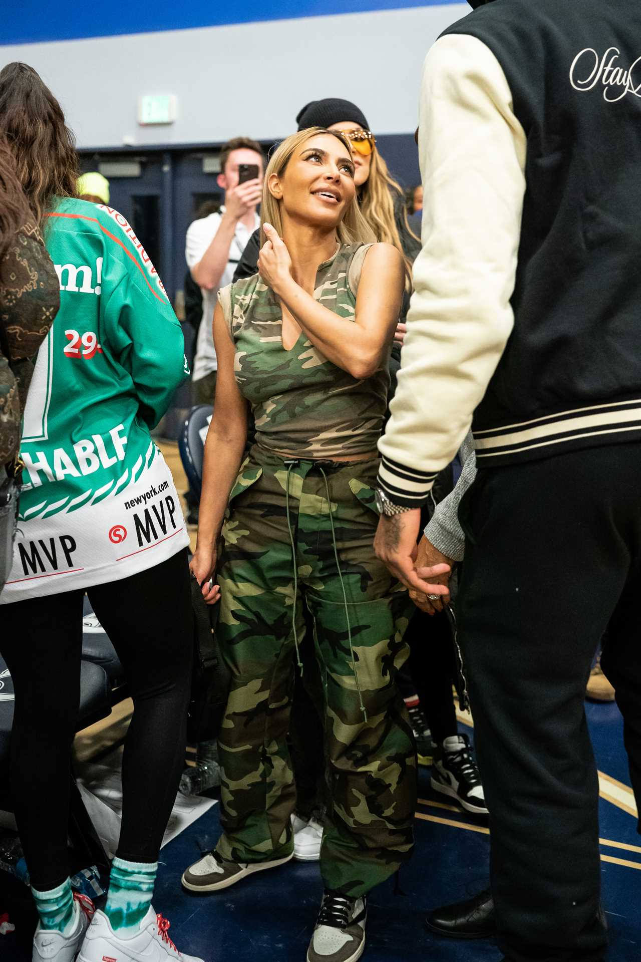 Kim Kardashian shows off her tiny waist in all-camouflage outfit for new photos- but fans blast ‘outdated’ look