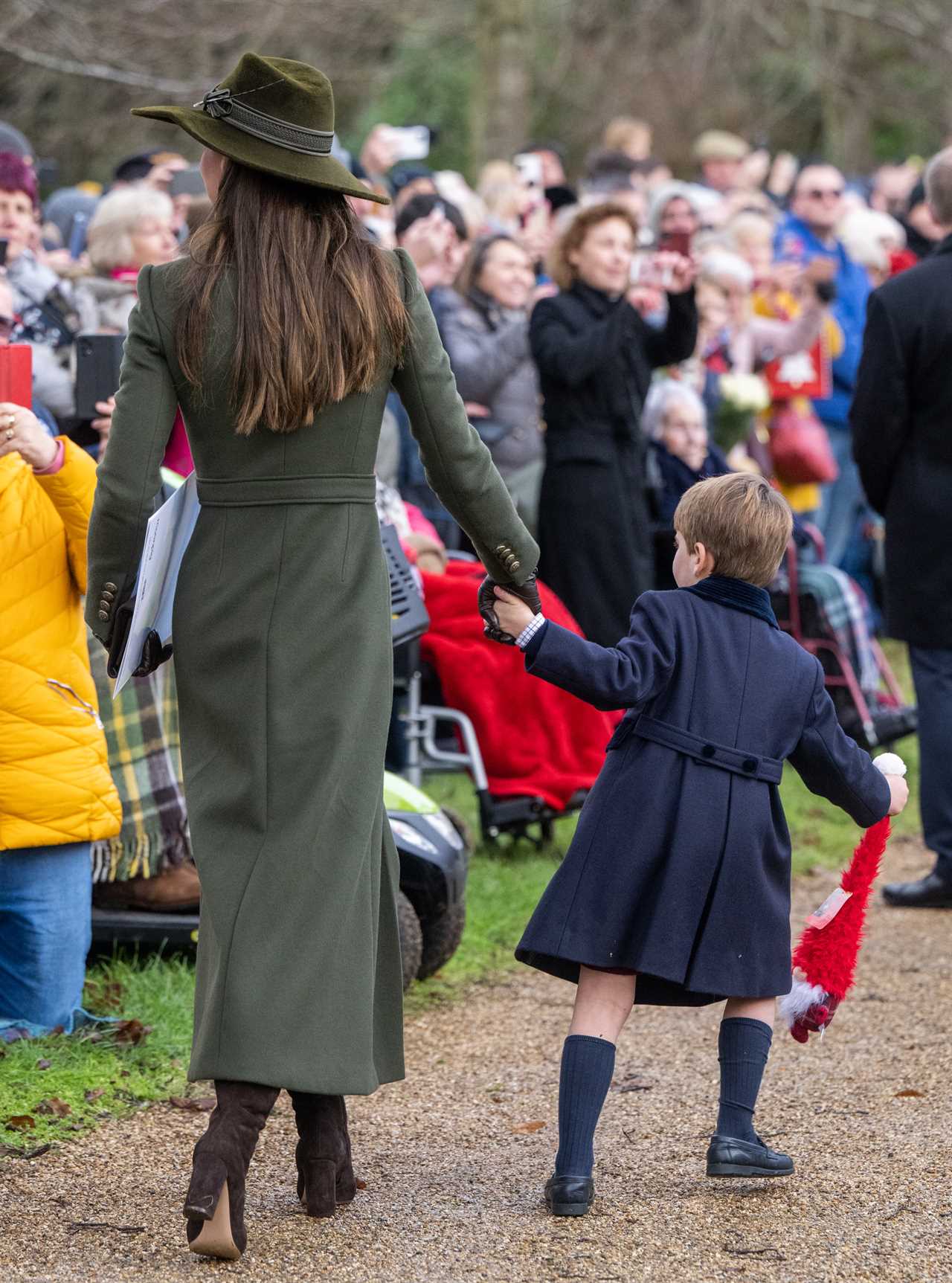 Prince Louis steals the show at Sandringham Christmas walk as delighted crowds shower him with gifts