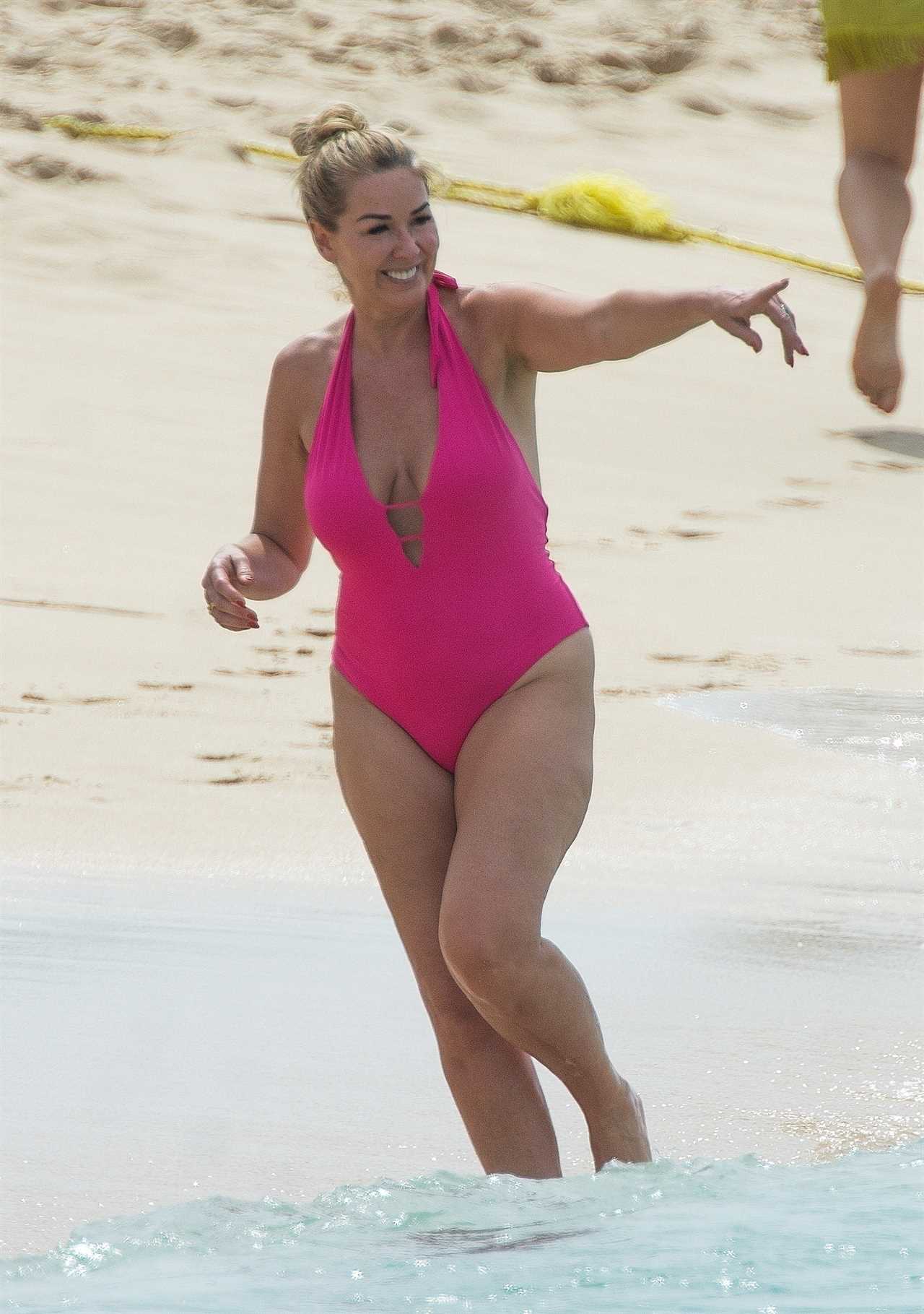 Claire Sweeney, 51, looks incredible as she hits the beach in Barbados in a bright pink swimsuit