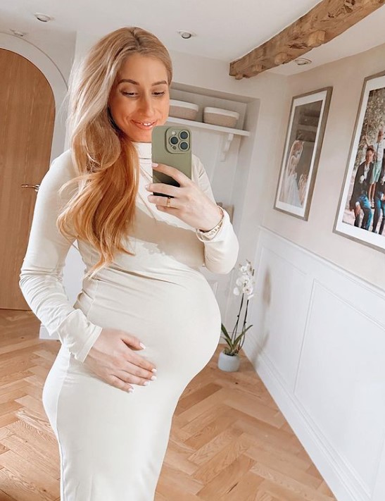 Pregnant Stacey Solomon is glowing as she cradles her bump in figure-hugging dress