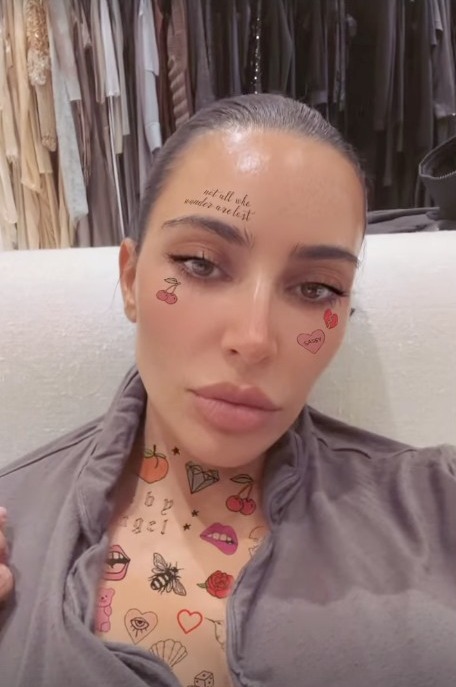 Kim Kardashian shows off intricate face & neck ‘tattoos’ in shocking new video after ex Kanye West’s ‘secret wedding’