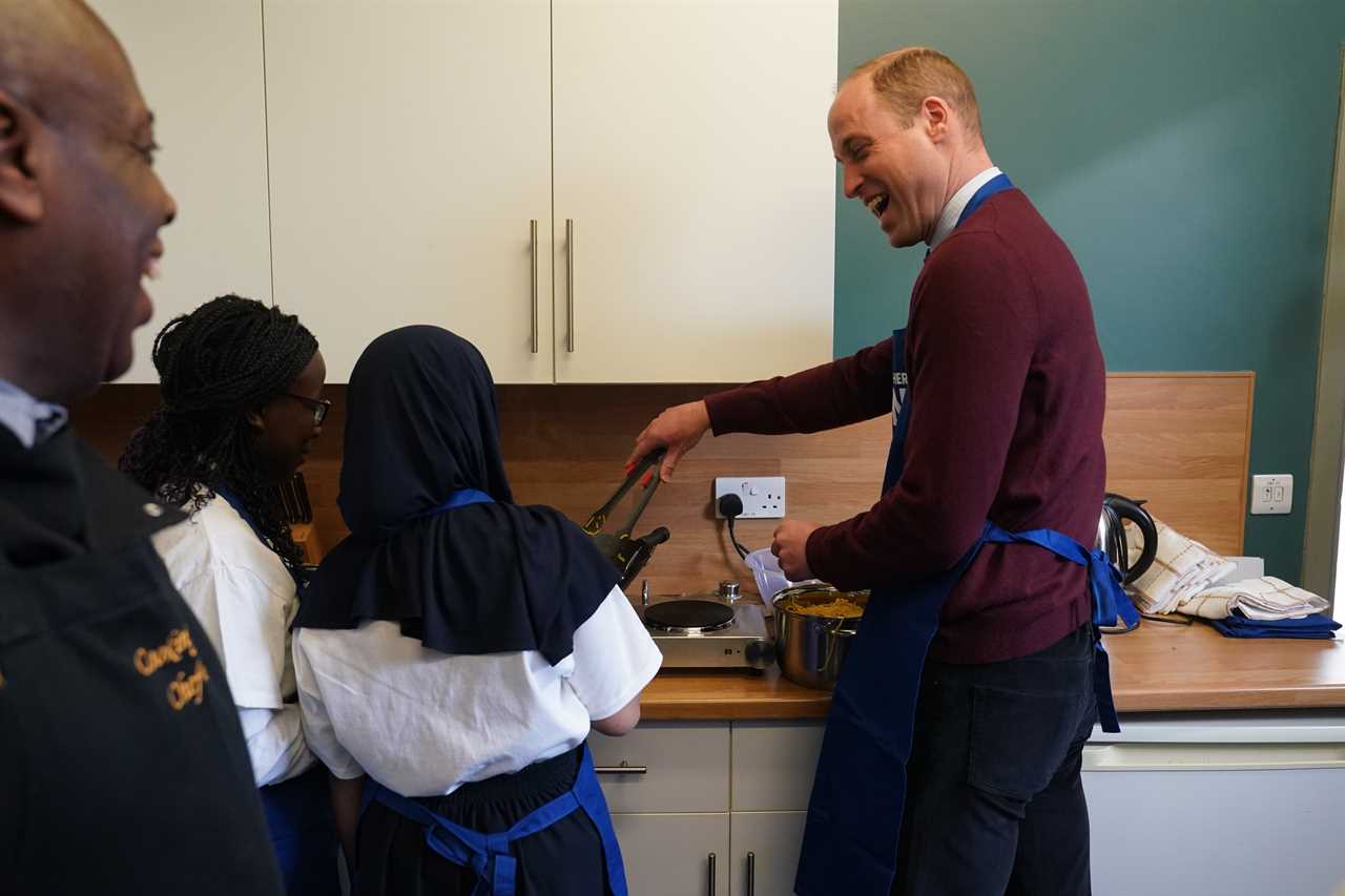 Prince William shrugs off brother Harry’s explosive bio as he focuses on Royal duties & cooks with kids on charity visit