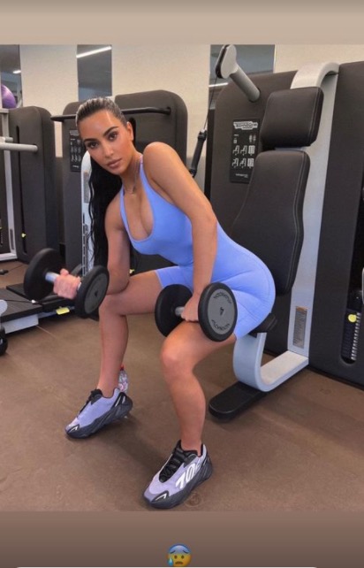 Kardashian fans catch a quick glimpse of Kim showing off her tiny waist in sports bra and tight leggings for a new video