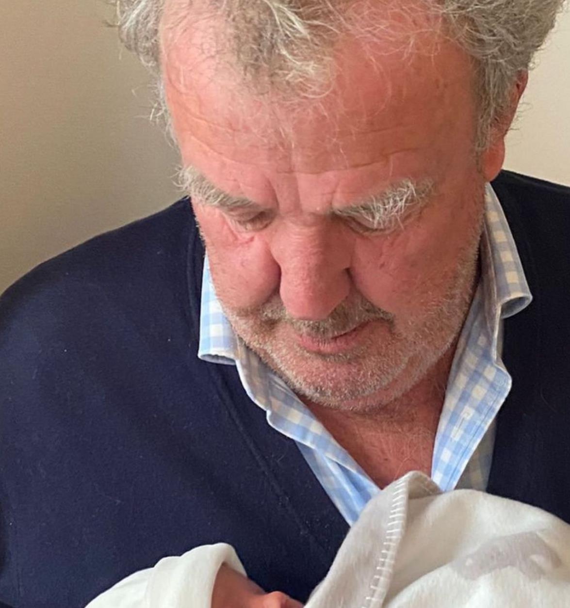 Jeremy Clarkson poses with new grandchild Arlo after daughter Emily gives birth