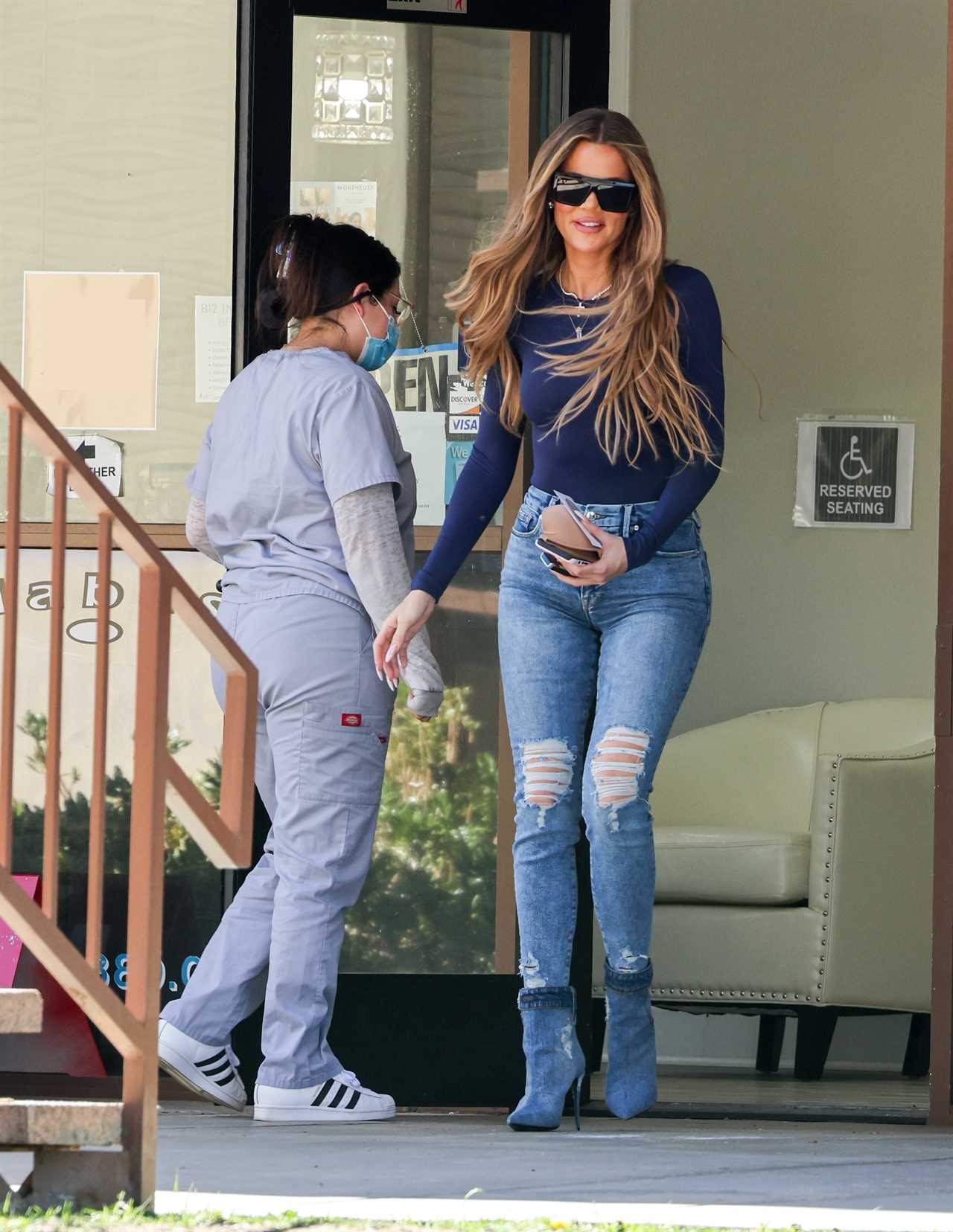 Khloe Kardashian flaunts skinny legs, tiny waist and famous butt as she’s seen clutching NSFW item in unedited new pics