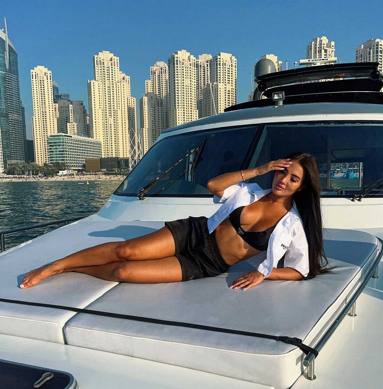 Yazmin Oukhellou poses in £175k Ferarri after quitting the UK for Dubai