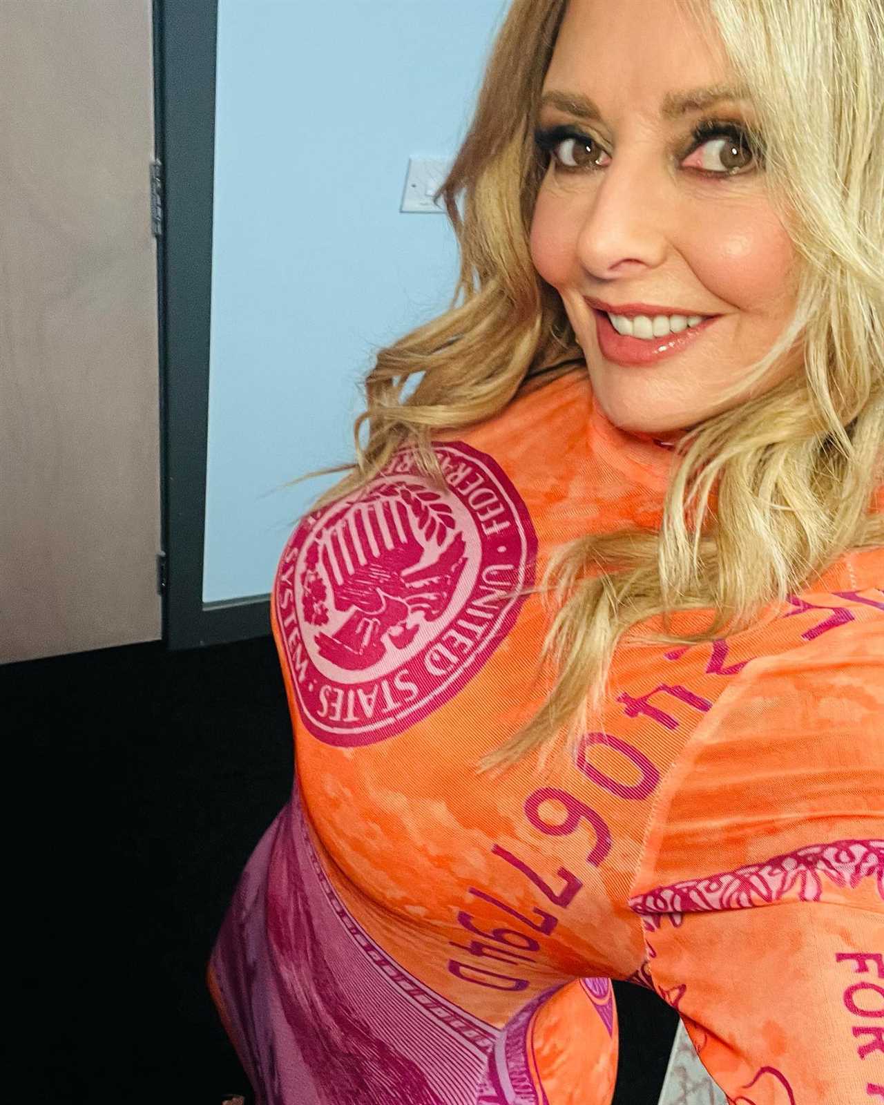 Carol Vorderman looks incredible as she shows off her curves in see-through red and orange dress