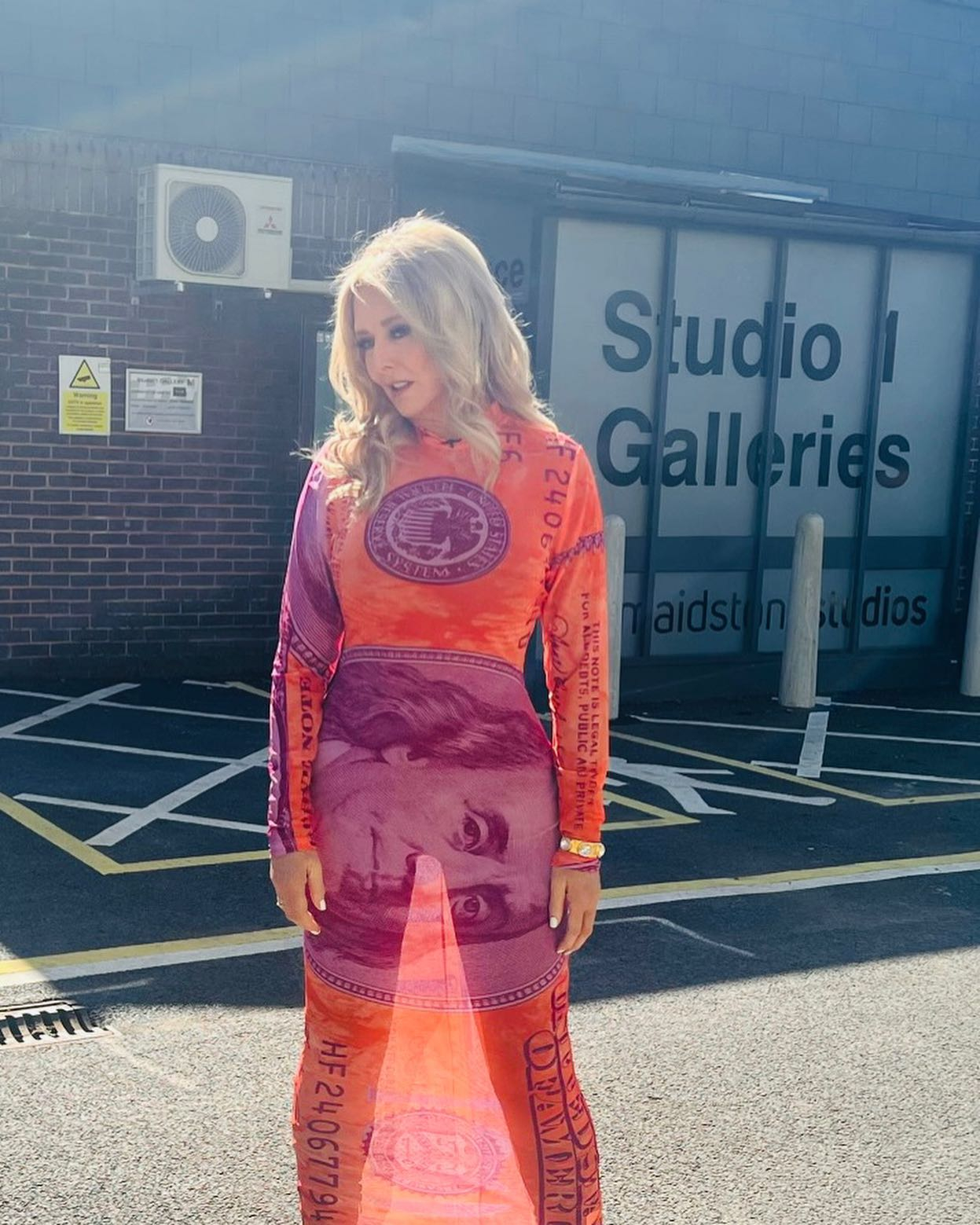 Carol Vorderman looks incredible as she shows off her curves in see-through red and orange dress