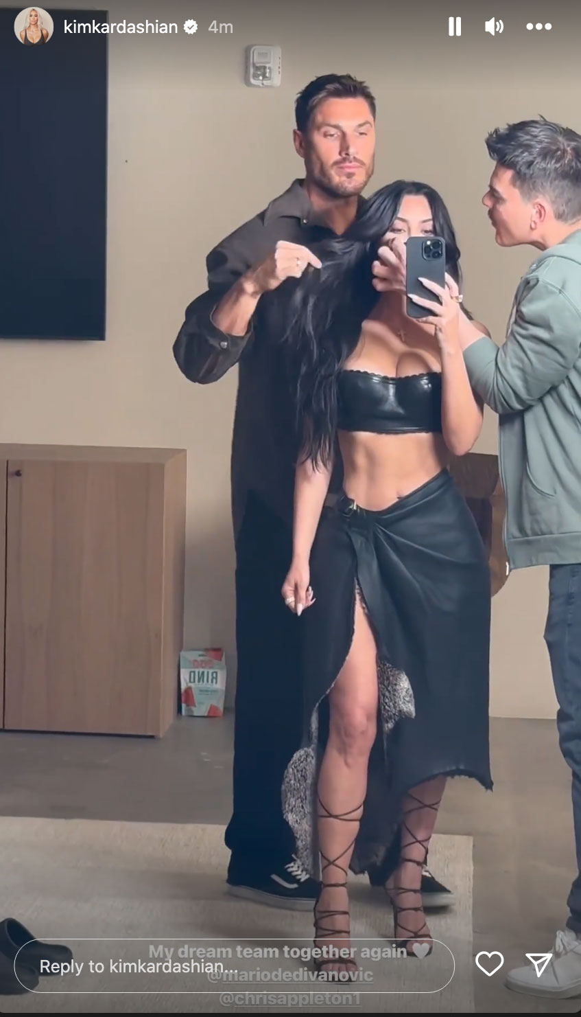 Kim Kardashian shows off skinny waist and goes pantless in just a loosely tied sarong and matching black leather bra