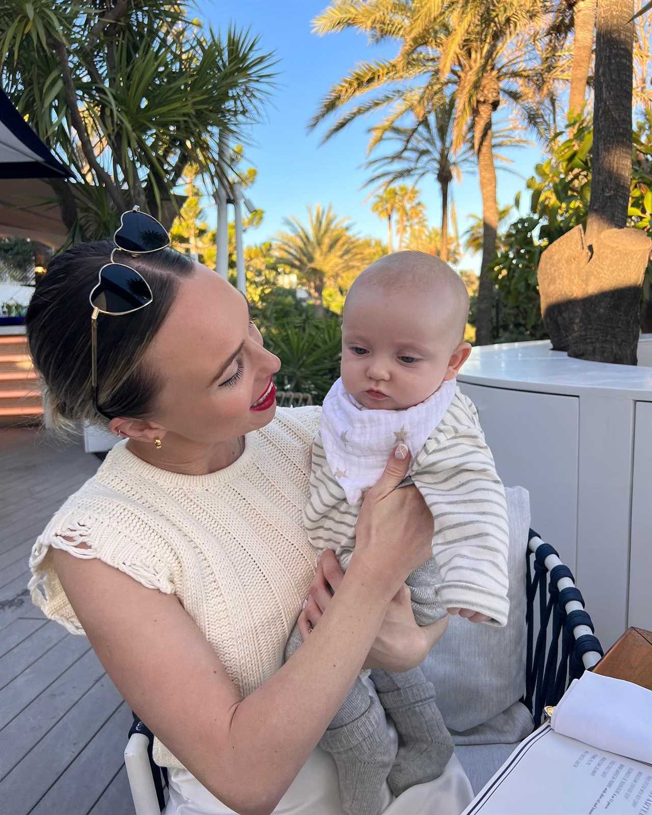 Jorgie Porter shows off natural beauty as she cuddles baby son on the beach on holiday