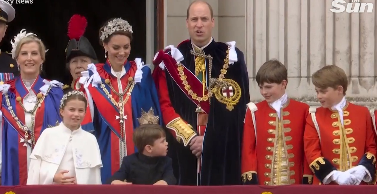 Adorable moment Prince Louis leans over to chat to big brother George as they brave rain on Buckingham Palace balcony