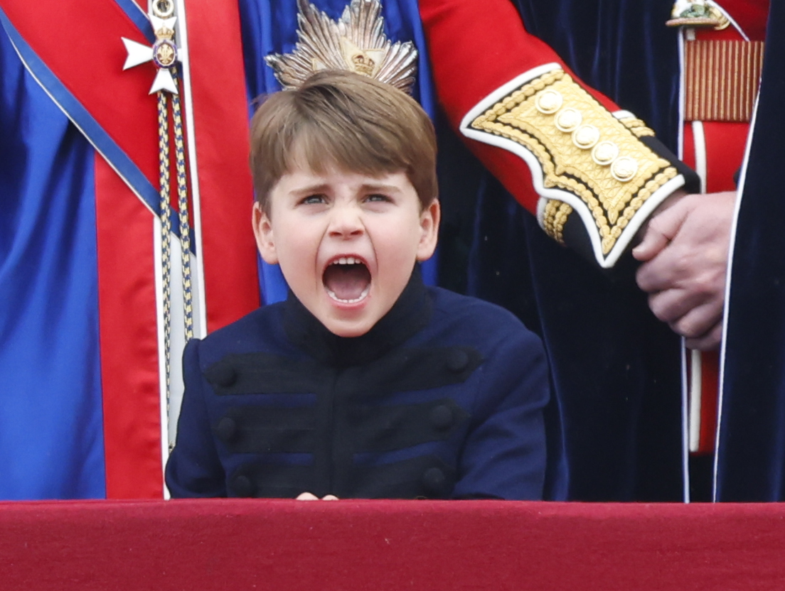 Adorable moment Prince Louis leans over to chat to big brother George as they brave rain on Buckingham Palace balcony