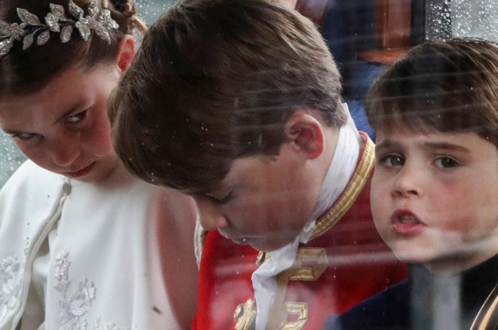 Adorable moment Prince Louis leans over to chat to big brother George as they brave rain on Buckingham Palace balcony