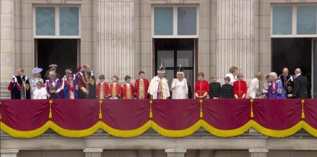 Adorable moment Prince Louis leans over to chat to big brother George as they brave rain on Buckingham Palace balcony