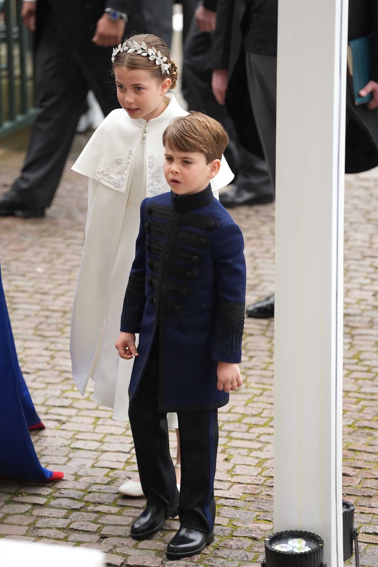 Adorable moment Prince Louis leans over to chat to big brother George as they brave rain on Buckingham Palace balcony