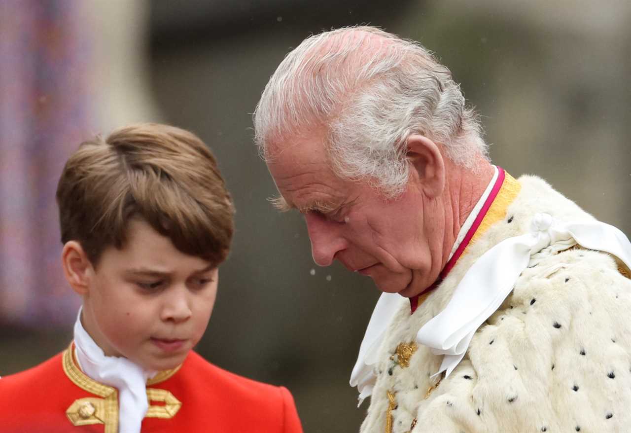 Adorable moment Prince Louis leans over to chat to big brother George as they brave rain on Buckingham Palace balcony