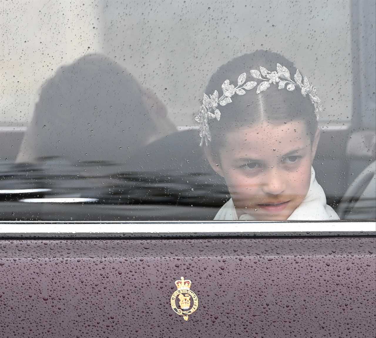 Adorable moment Prince Louis leans over to chat to big brother George as they brave rain on Buckingham Palace balcony