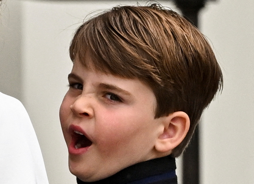 Adorable moment Prince Louis leans over to chat to big brother George as they brave rain on Buckingham Palace balcony