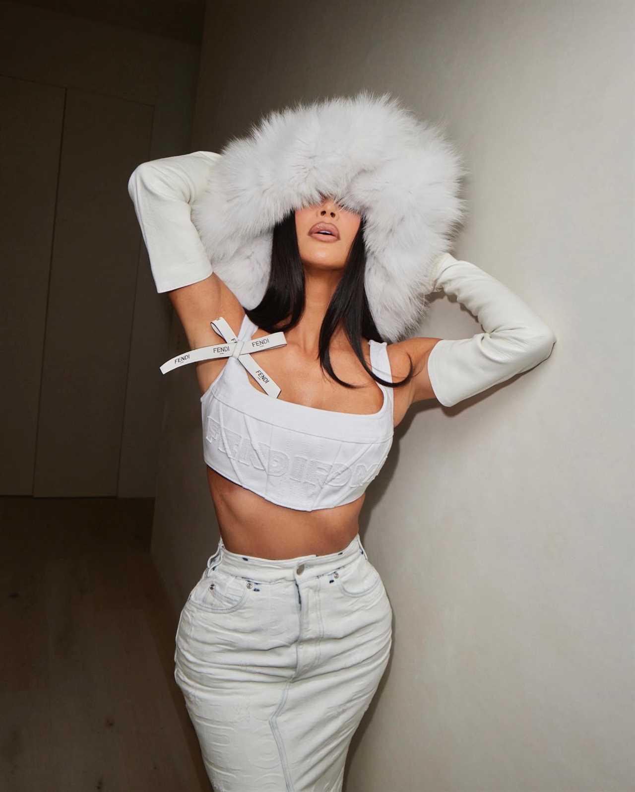 Kim Kardashian flaunts her ultra tiny waist in white crop top and denim skirt for new photos after major weight loss