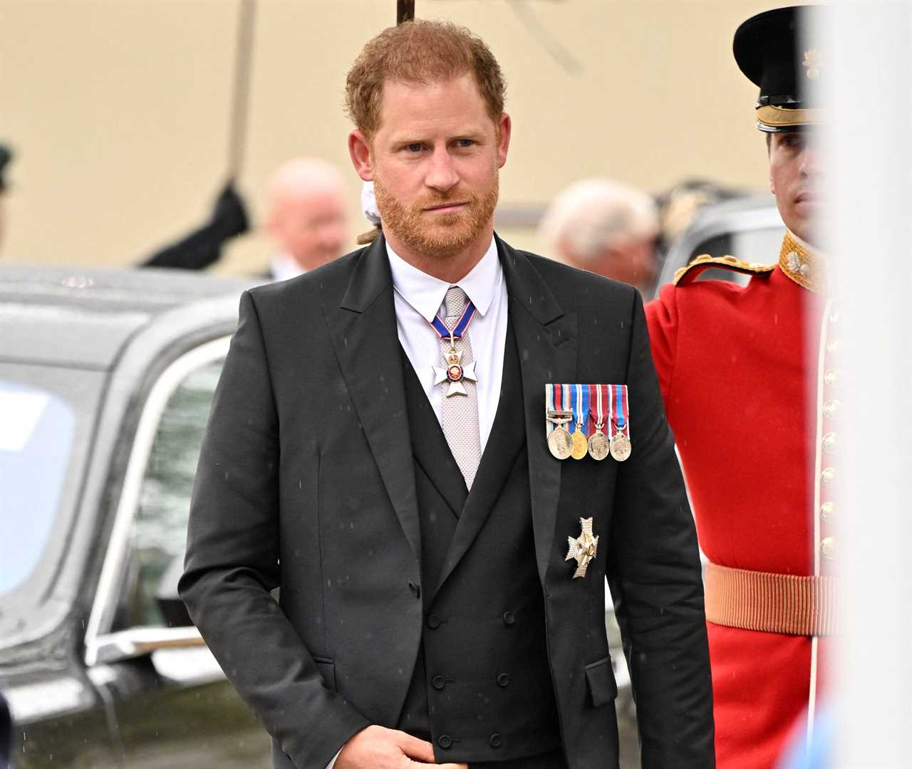 Prince Harry smiles despite sitting in third row after arriving separately from brother William at dad’s coronation