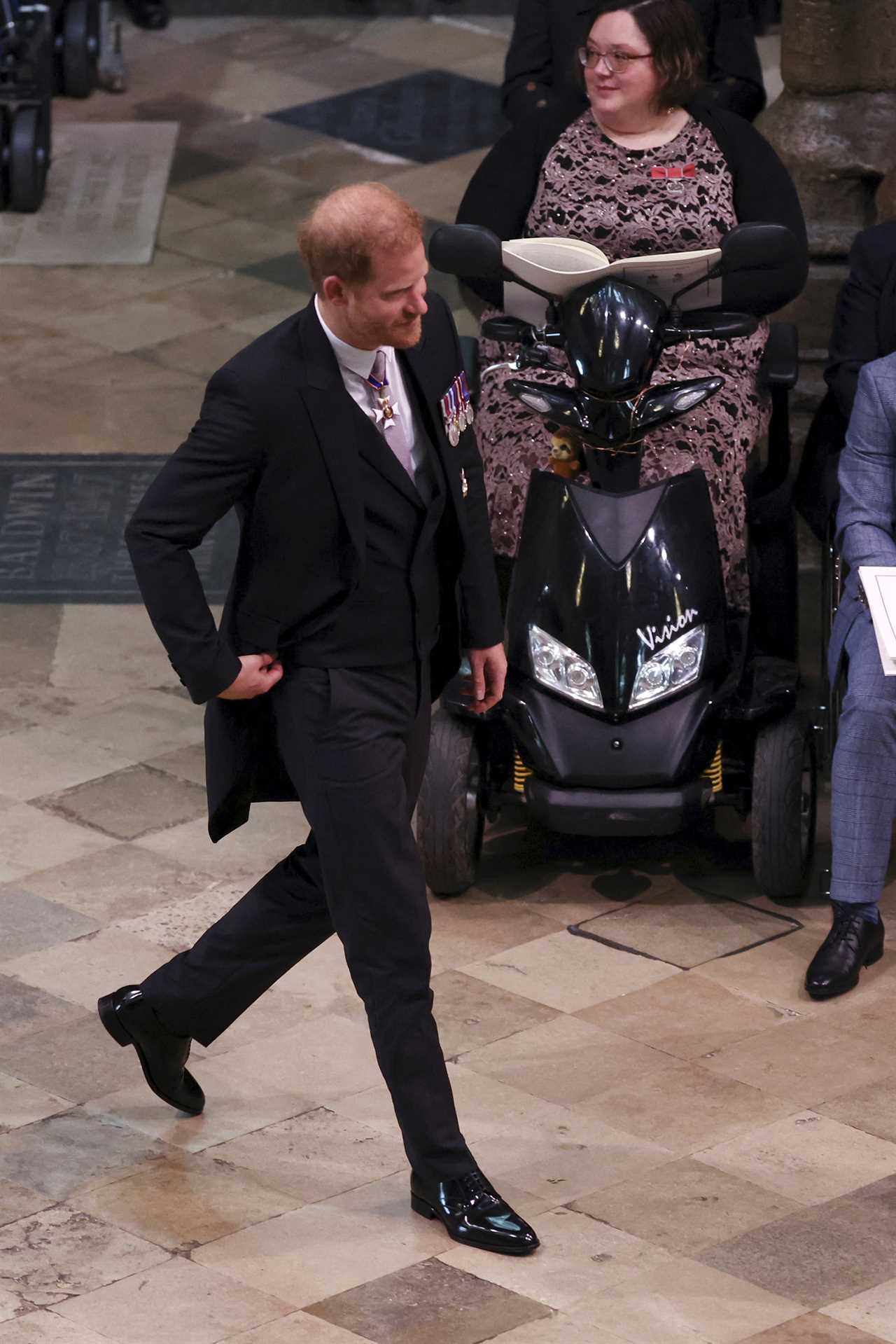 Prince Harry smiles despite sitting in third row after arriving separately from brother William at dad’s coronation