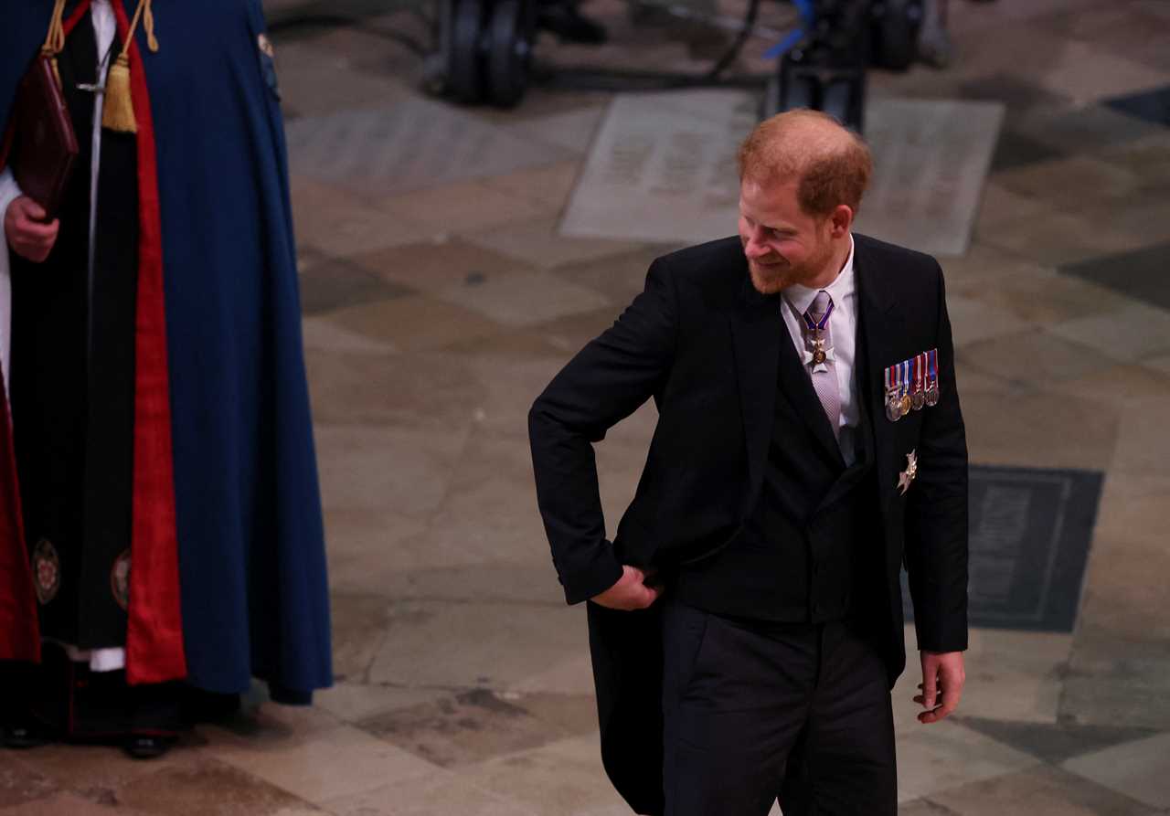 ‘Cocky’ Prince Harry is defiant and ‘without shame’ as he walks into coronation alone, says body language expert