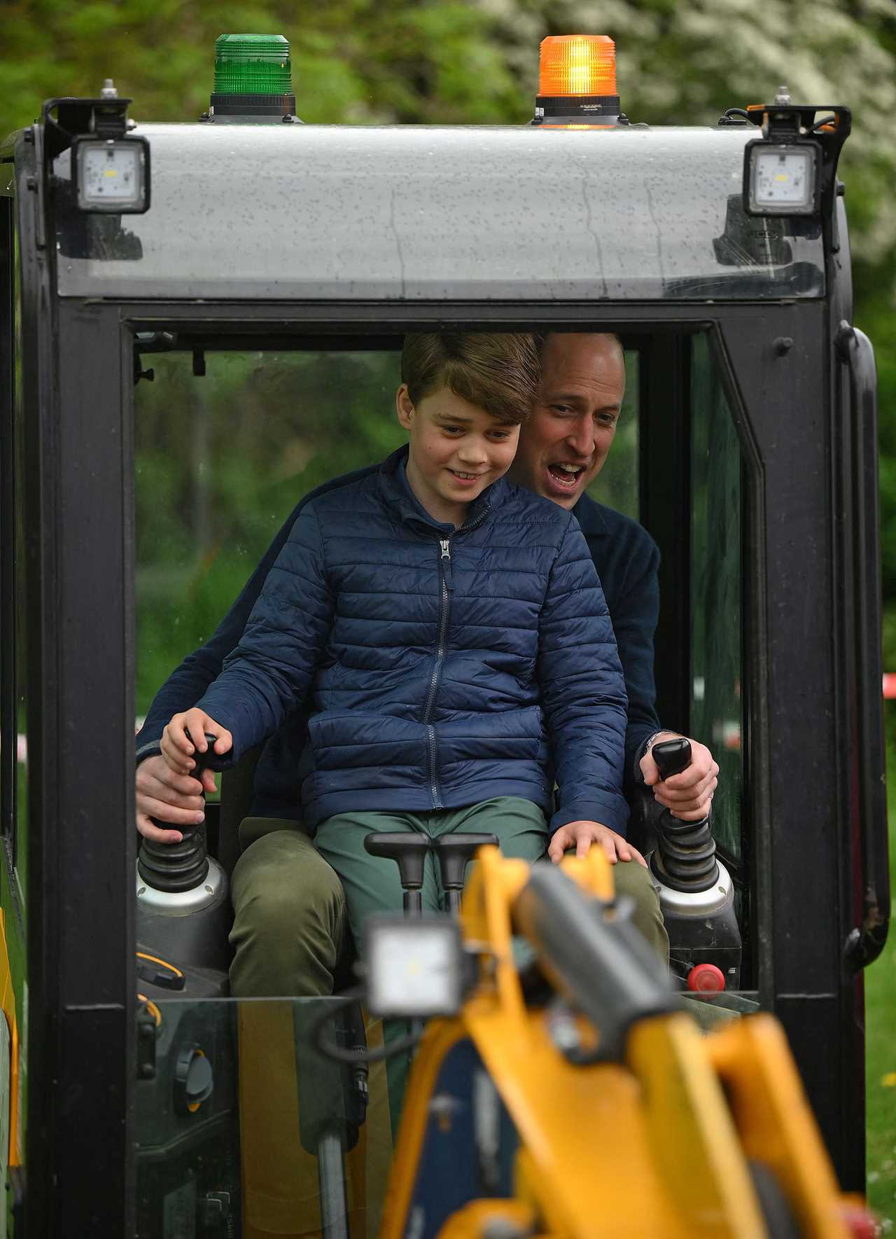 Hardworking Prince Louis rides digger and fills wheelbarrow as Charlotte paints fence on visit with William and Kate