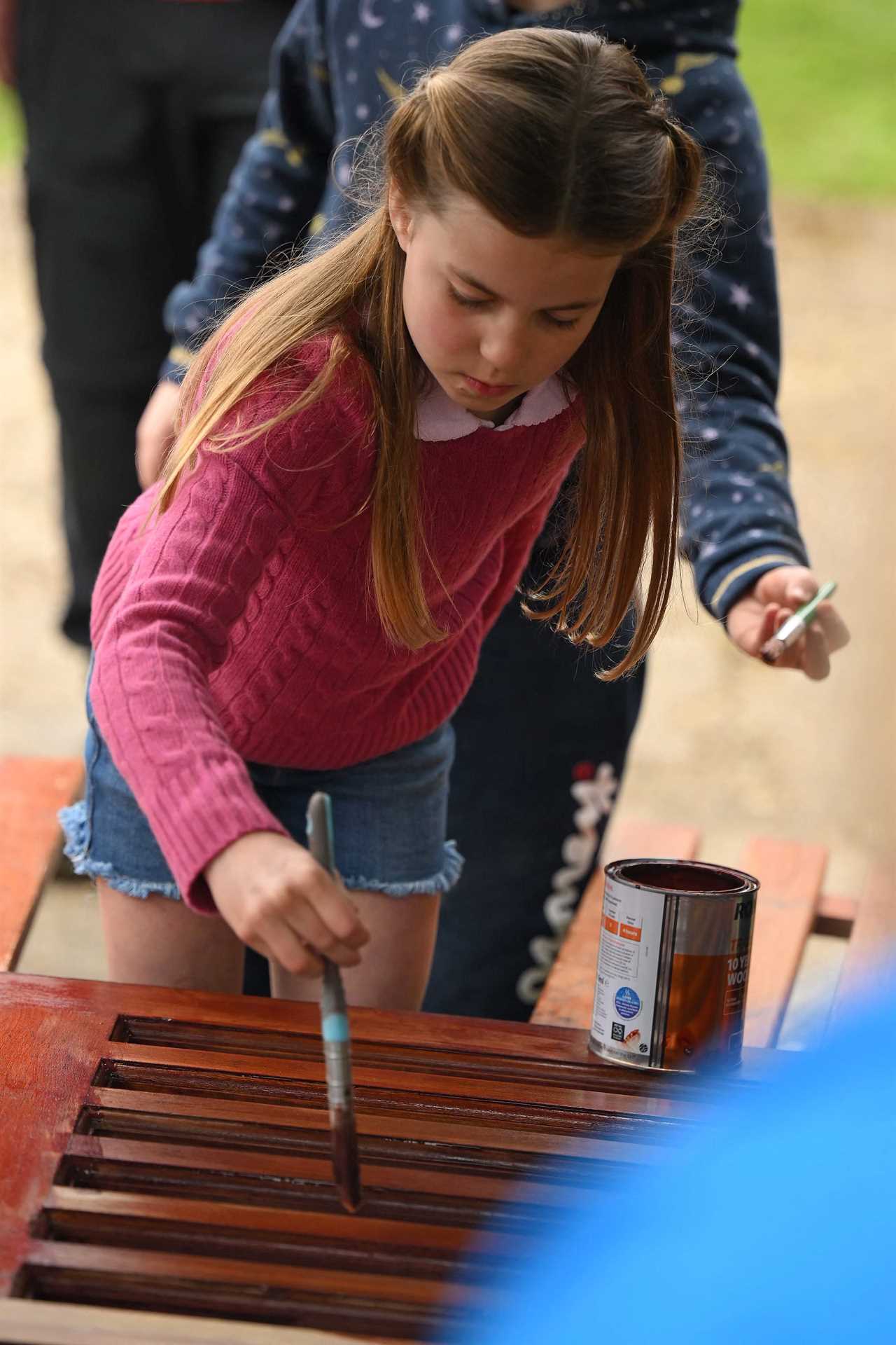 Hardworking Prince Louis rides digger and fills wheelbarrow as Charlotte paints fence on visit with William and Kate