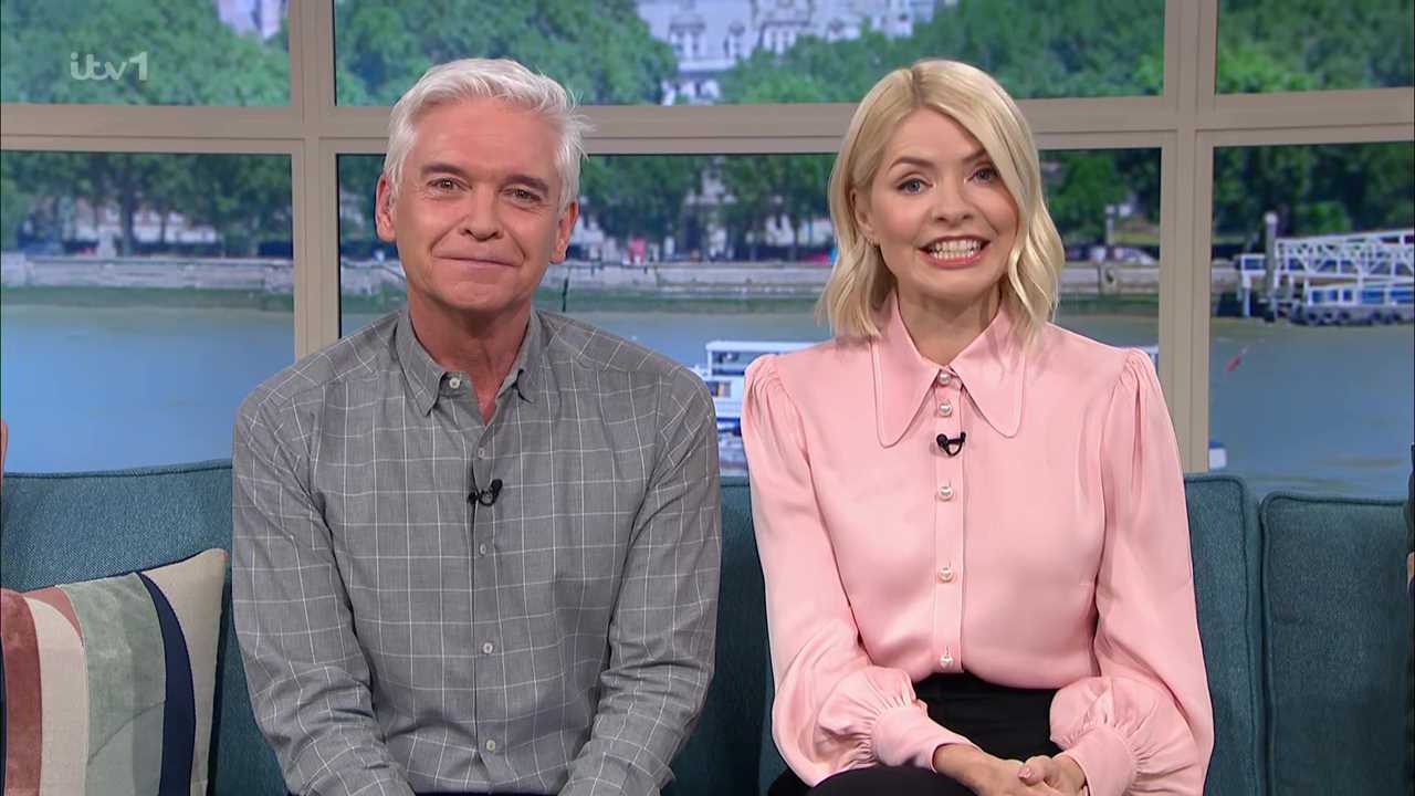 Holly Willoughby is all smiles as she poses behind the scenes of This Morning before reuniting with Phillip Schofield