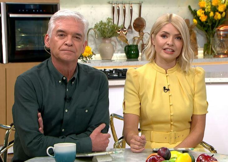 Holly Willoughby puts Phillip Schofield feud behind her as she laughs with King Charles after leaving This Morning early
