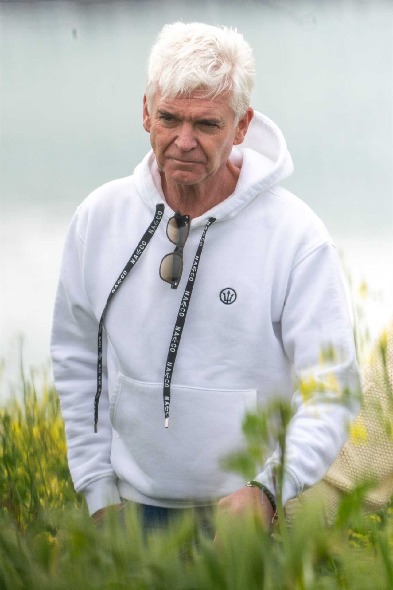 EXCLUSIVE: Phillip Schofield shares emotional walk with mum Pat today in the West Country as his brother Timothy is jailed for 12 years over sexual acts with a minor. ..The pair hugged and also laughed as they strolled in the sunshine, stopping for an embrace on a bench before sharing happy moments along the coastal path. Pat, 85, will be 91 before Timothy is eligible for parole.....Pictured: Phillip Schofield..Ref: SPL6856491 190523 EXCLUSIVE..Picture by: Spartacus / SplashNews.com....Splash News and Pictures..USA: 310-525-5808.UK: 020 8126 1009..eamteam@shutterstock.com....World Rights..
