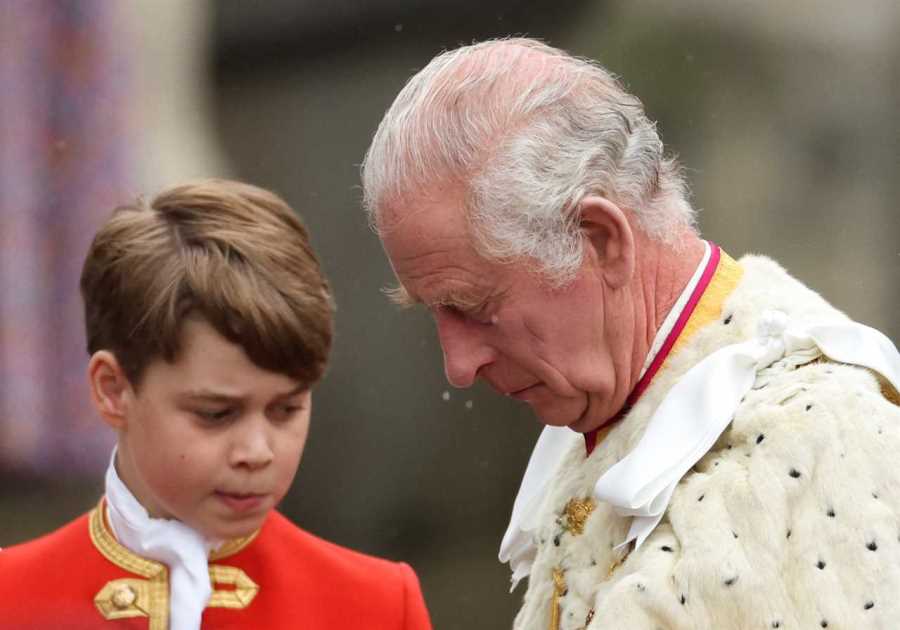 Prince 9, looks solemn as he holds his grandfather