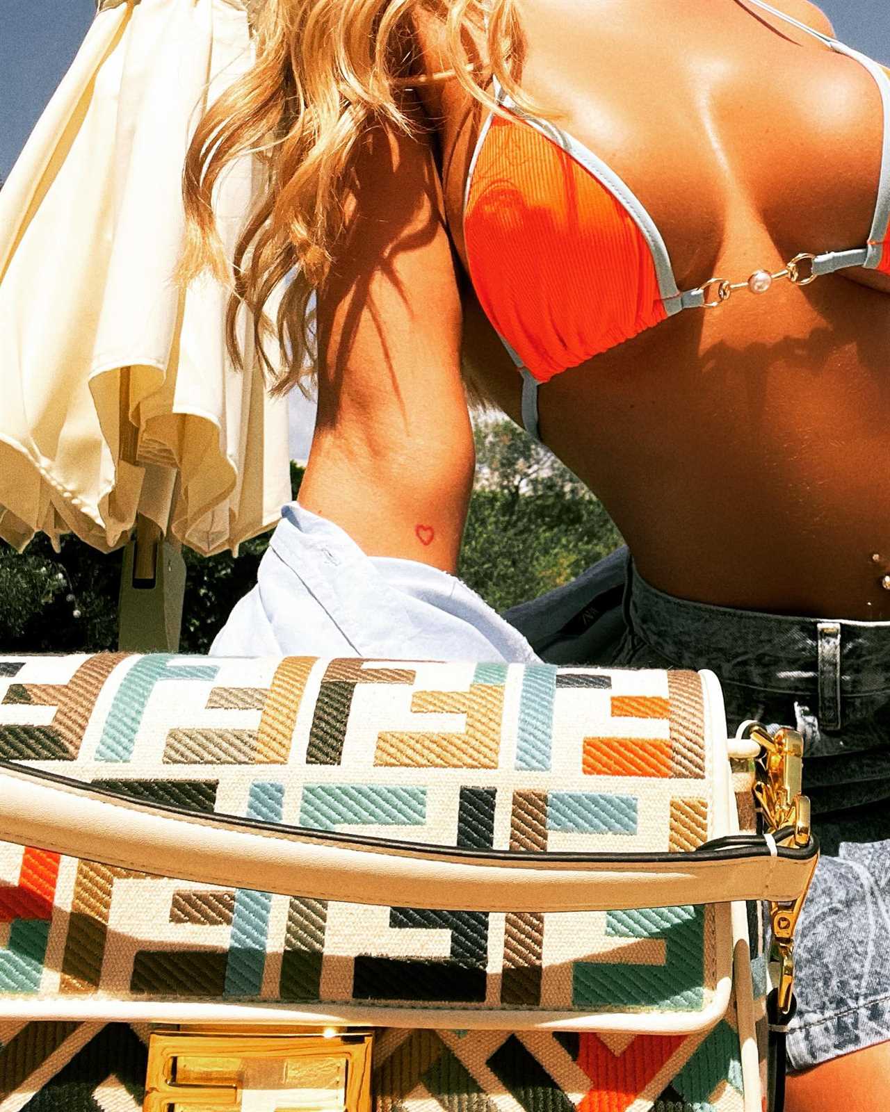 Love Island’s Megan Barton Hanson shows off toned abs in tiny orange bikini top