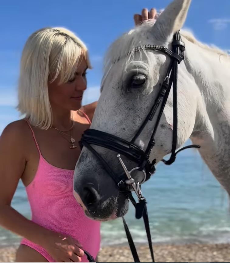 A Place In The Sun’s Danni Menzies wows in pink swimsuit as she rides a horse into the sea in Corfu