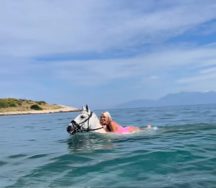 A Place In The Sun’s Danni Menzies wows in pink swimsuit as she rides a horse into the sea in Corfu