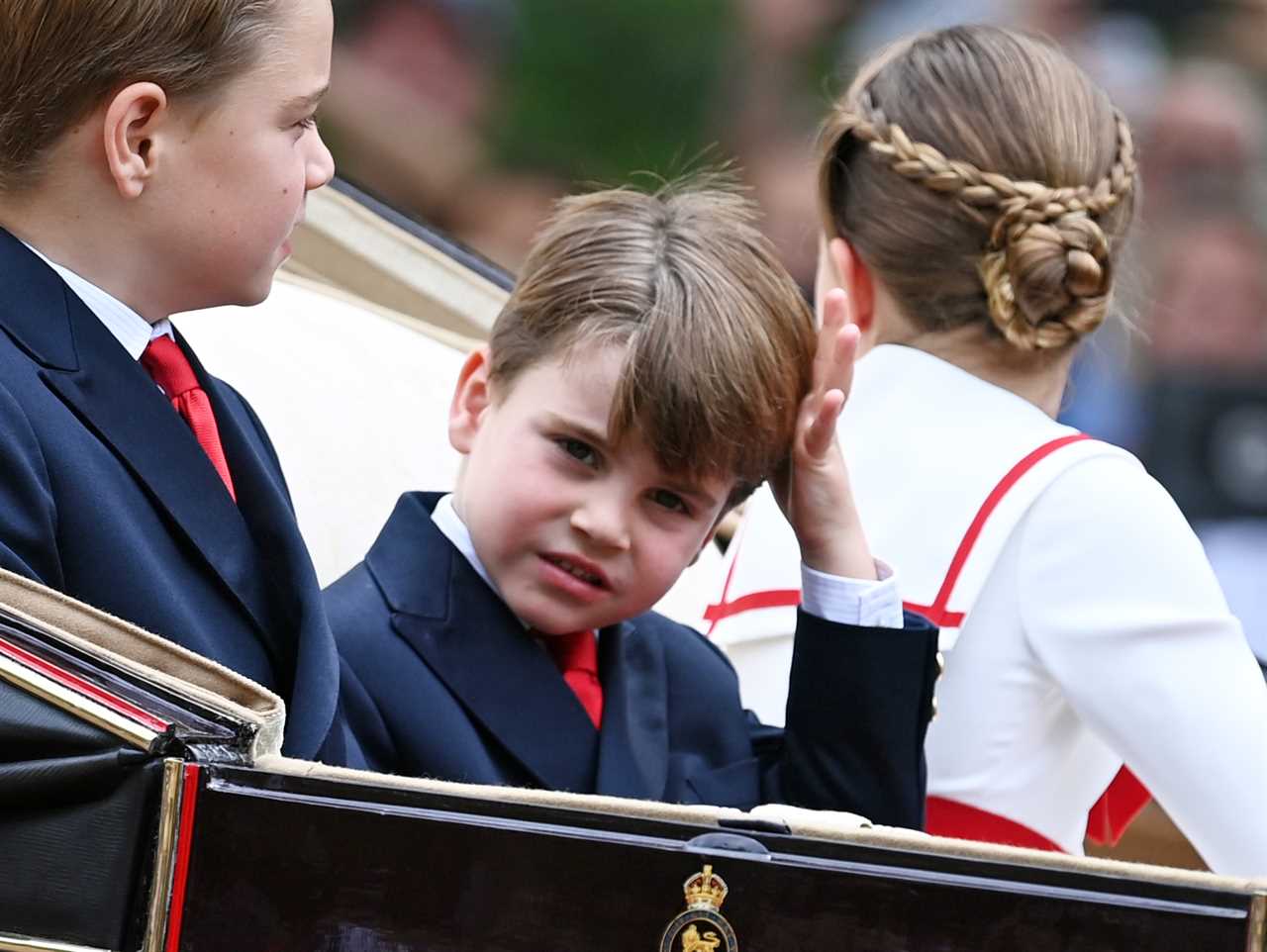 Prince Louis steals the show again as cheekiest royal holds his nose, pulls a face and fidgets with his hair