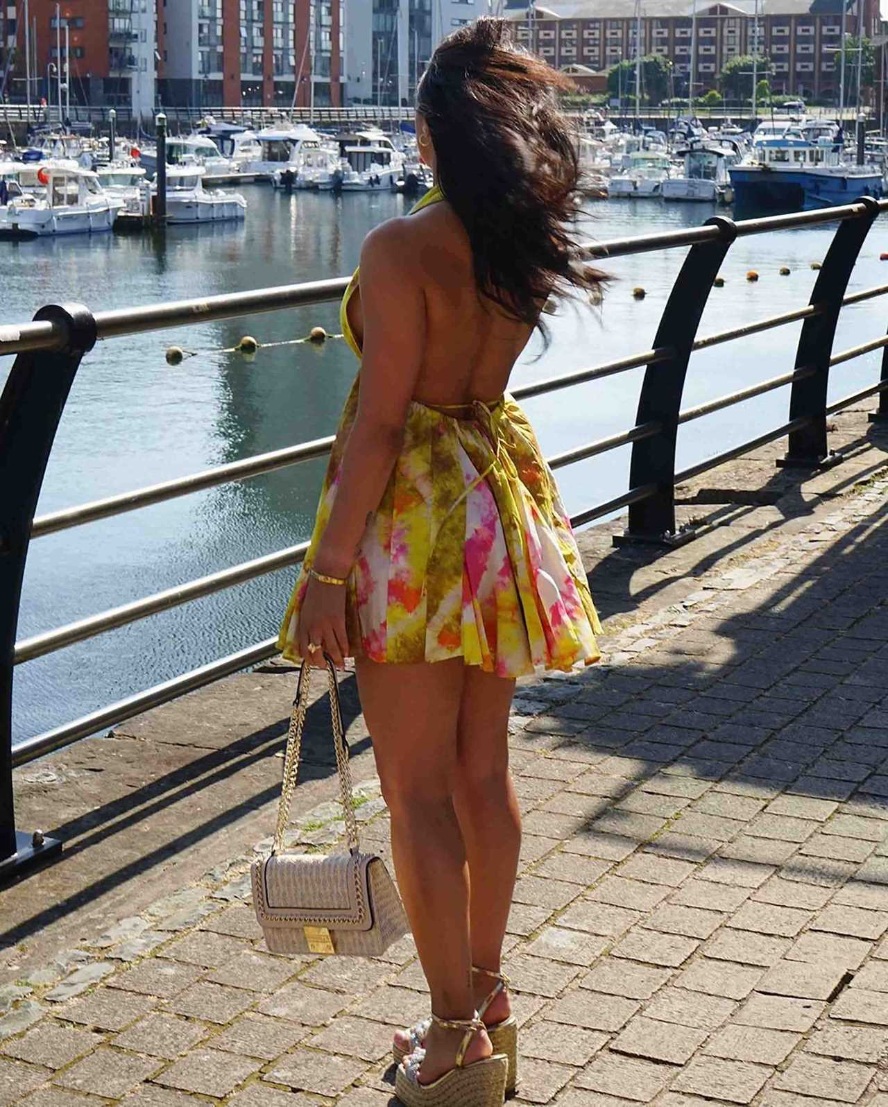 Love Island star Paige Thorne goes braless in plunging summer dress as she enjoys the sun in Cardiff