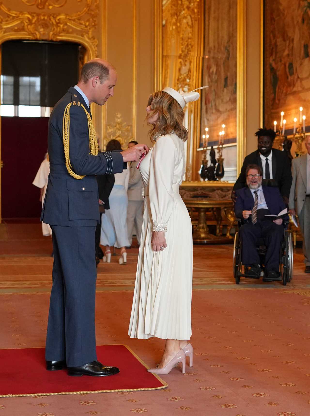 Kate Garraway is watched by proud husband Derek Draper as she gets MBE from Prince William