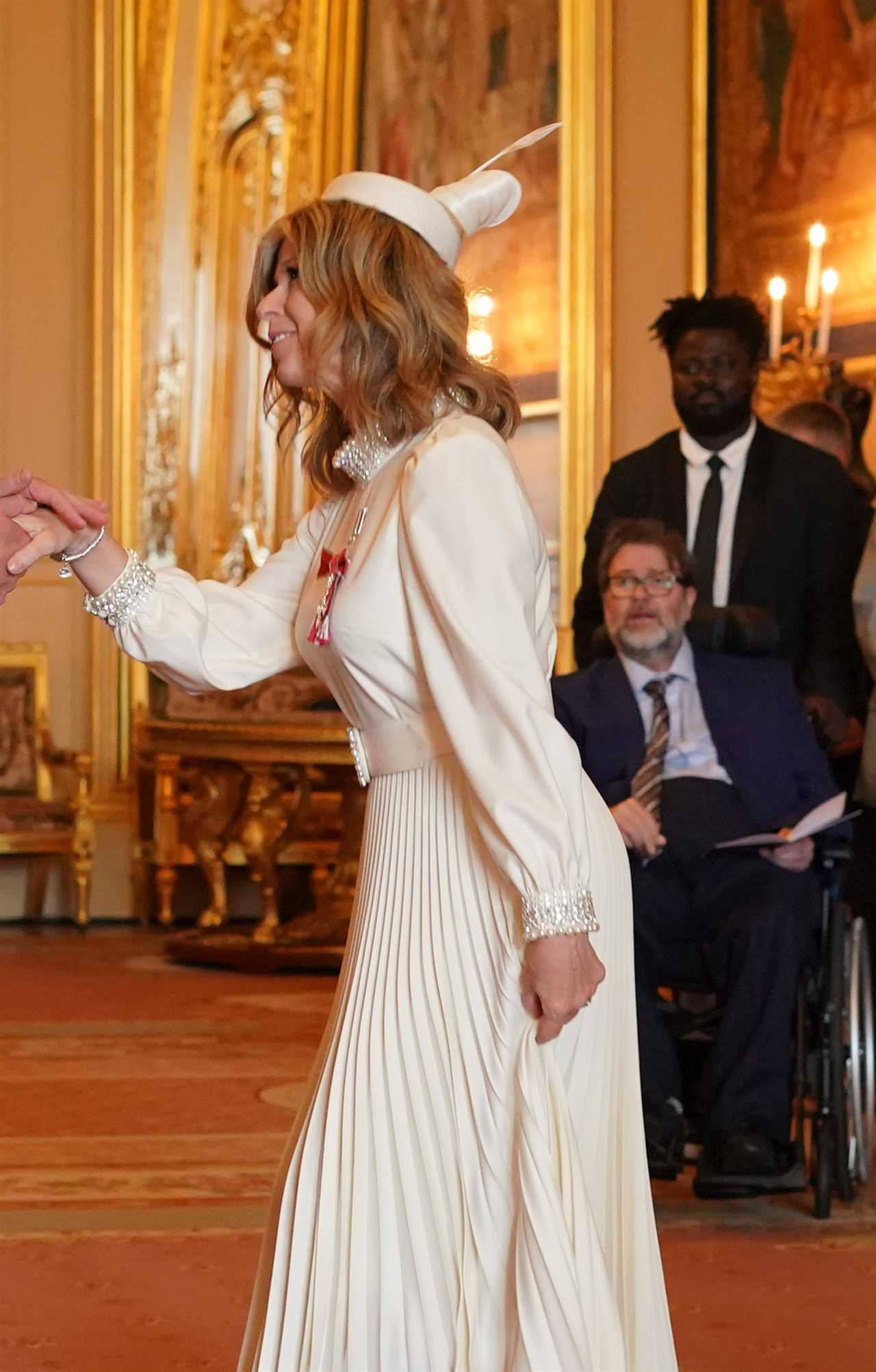 Kate Garraway is watched by proud husband Derek Draper as she gets MBE from Prince William