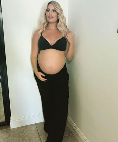 Towie’s Danielle Armstrong shows off her huge baby bump as she poses in a bra