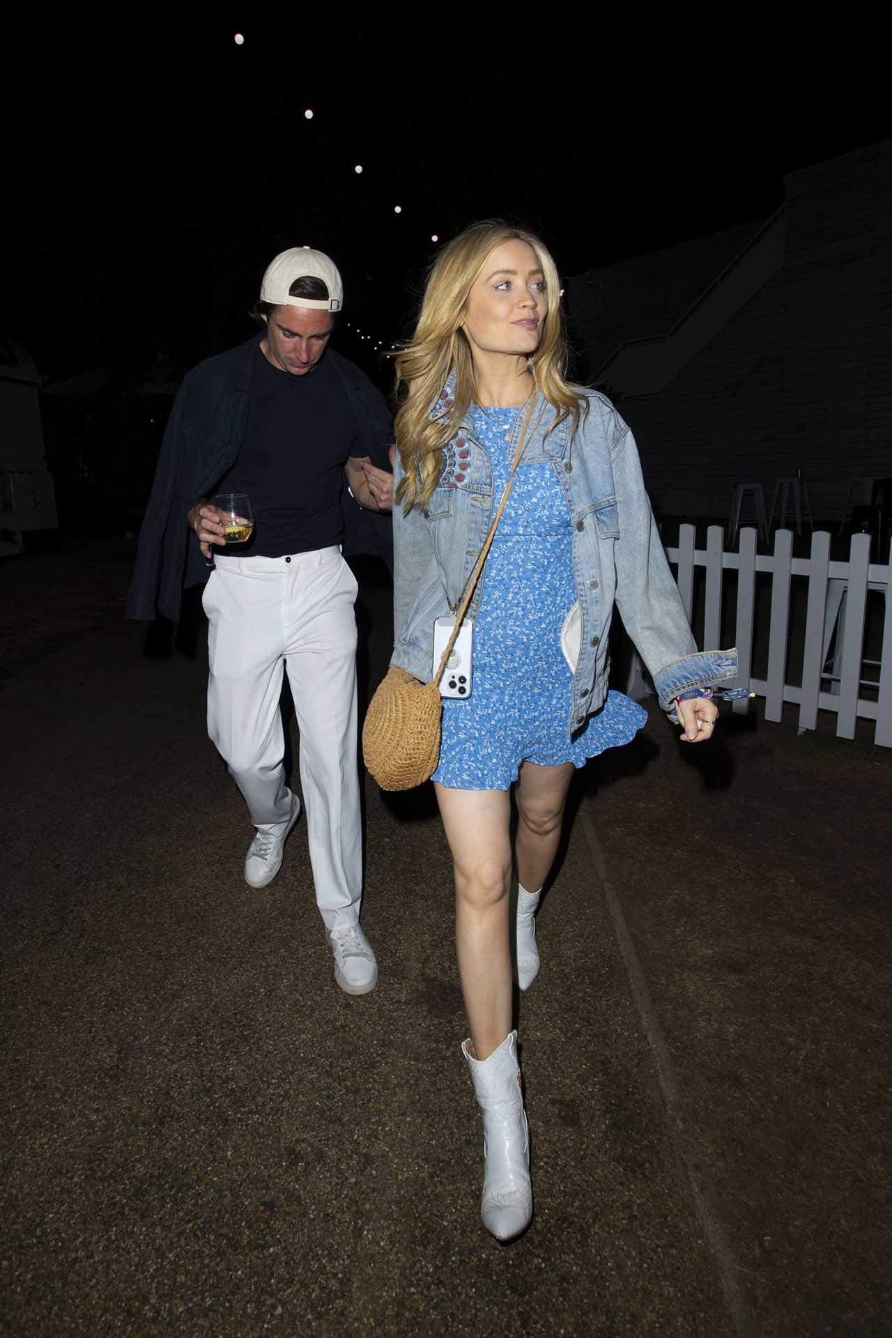 Laura Whitmore holds hands with close pal as she leaves BST Hyde Park after watching Take That