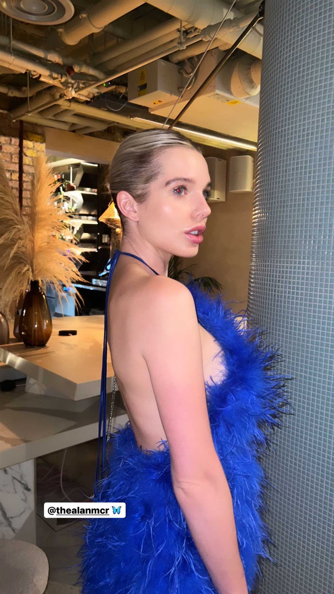 Helen Flanagan stuns as she goes braless as she poses in blue feathered dress