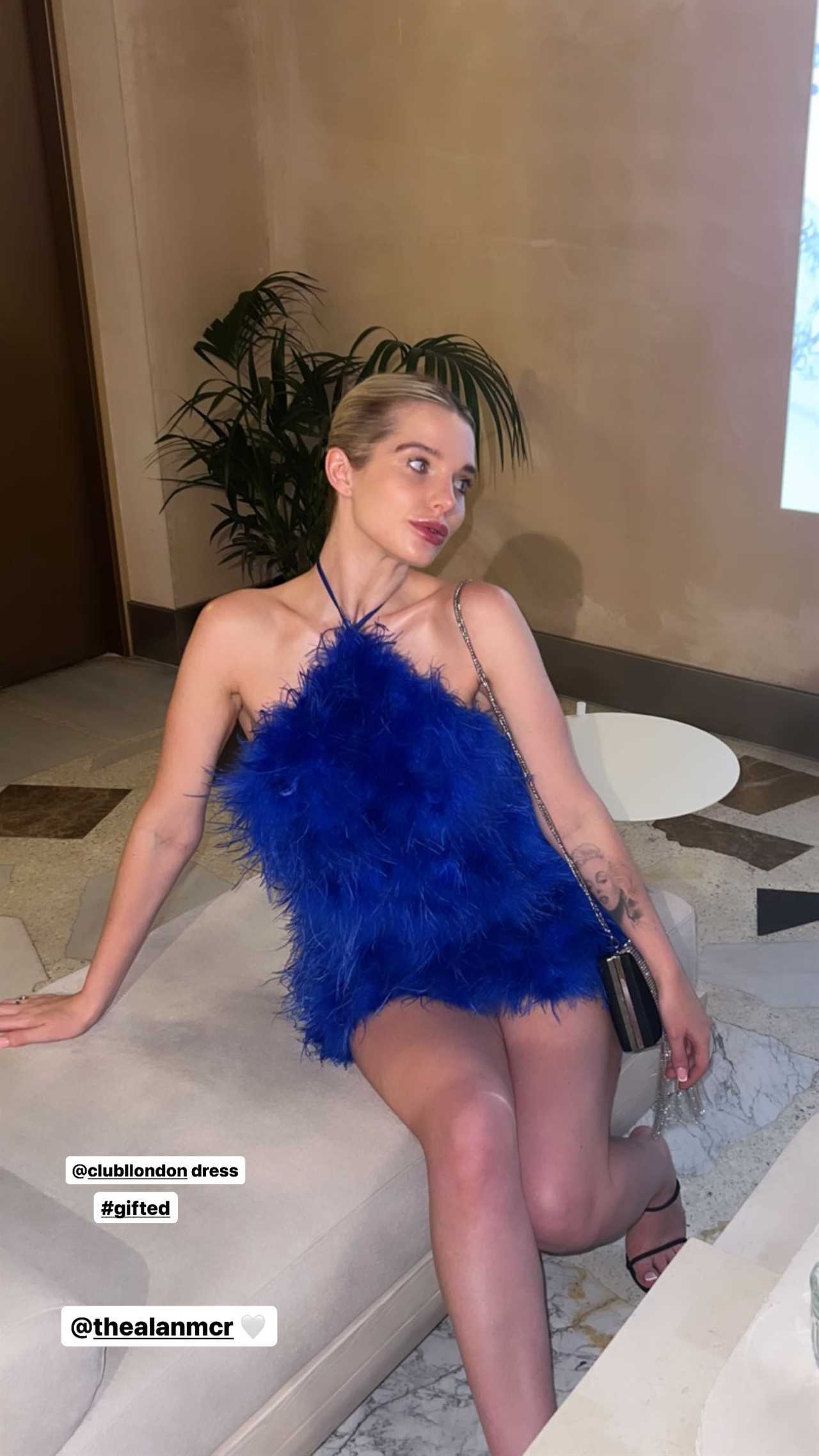 Helen Flanagan stuns as she goes braless as she poses in blue feathered dress