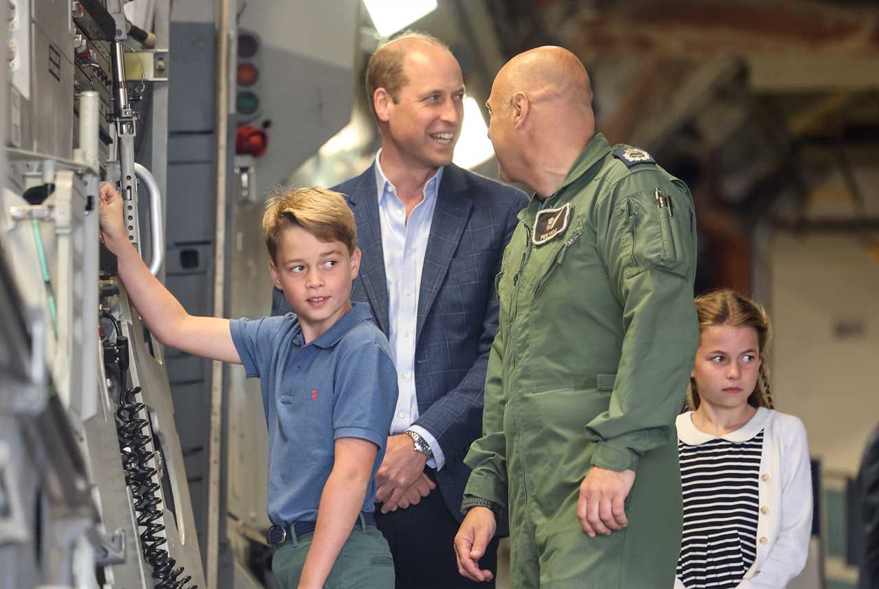 Prince Louis gives a shy wave as Kate helps him climb onto a quad bike during family day out with siblings at air show